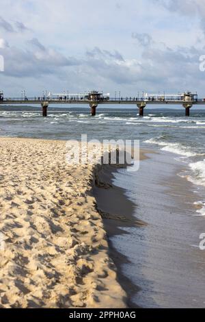 Miedzyzdroje pier, long wooden jetty entering the Baltic Sea from the beach, West Pomerania Province, Miedzyzdroje, Poland Stock Photo