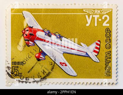 USSR - CIRCA 1986: Post stamp 5 copeck shows Yakovlev UT-2 Mink, single-engine tandem two-seat low-wing monoplane, Soviet trainer during Great Patriotic War. Printed the Soviet Air Force series stamps. Stock Photo