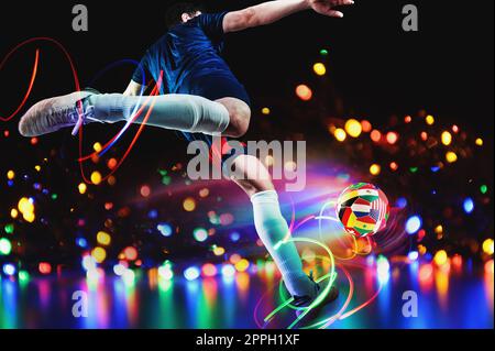 Football player kicks the soccerball with team national flags of qatar 2022 Stock Photo