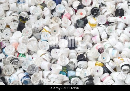 A pattern of many used and soiled nozzles from spray cans with aerosol paint. Background texture of the street art of drawing graffiti on the walls Stock Photo