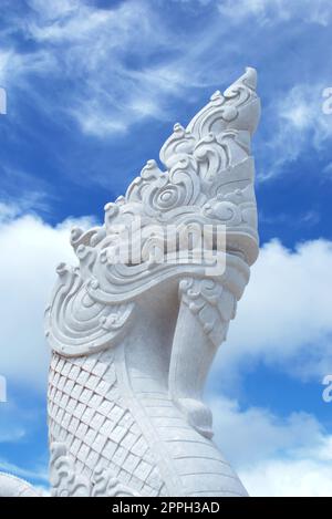 White marble statue of a buddhist Naga serpent in Thailand. Close up detail. Stock Photo