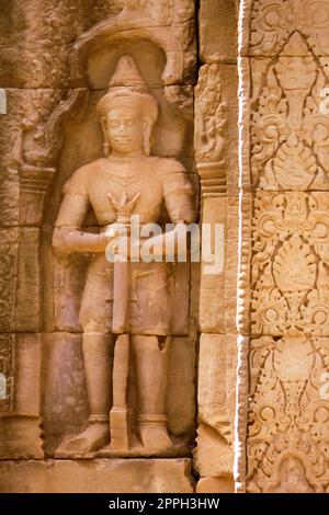 Ancient soldier bas-relief on a wall at Banteay Kdei temple ruins, in Angkor Wat complex near Siem Reap, Cambodia. Stock Photo