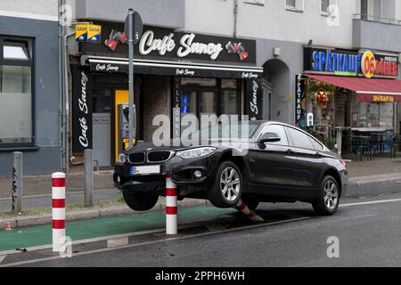 In the early hours of the morning, a passenger car hit the bollards of a bicycle path in the traffic-calmed HermannstraÃŸe (speed 30 km/h) in Berlin and suffered considerable damage to the underbody and engine compartment. The driver fled and left the veh Stock Photo