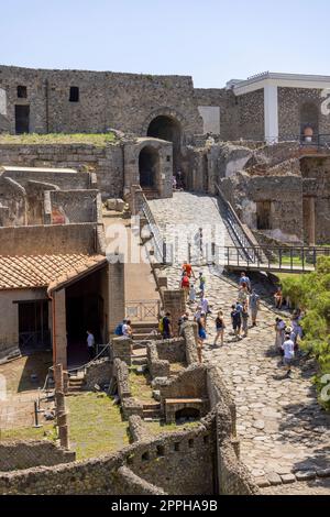 Tourists at the entrance to ancient city destroyed by the eruption of the volcano Vesuvius, Pompeii, Naples, Italy Stock Photo