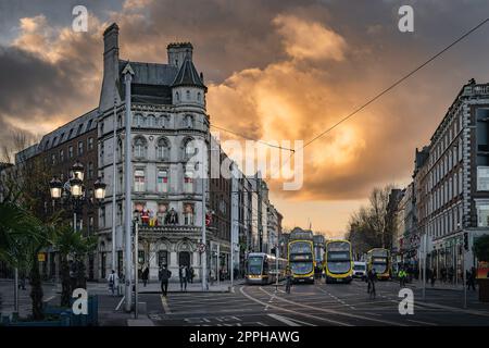 Early morning, sunrise, on busy OConnell Bridge with Luas and bus, Dublin, Ireland Stock Photo