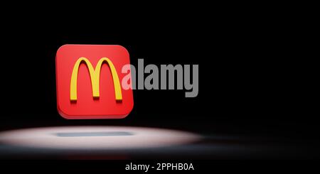 McDonalds Logo Spotlighted on Black Background Stock Photo