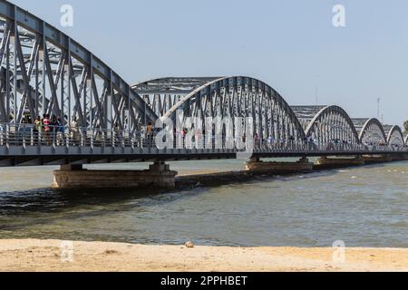 people cross the Faidherber bridge Stock Photo