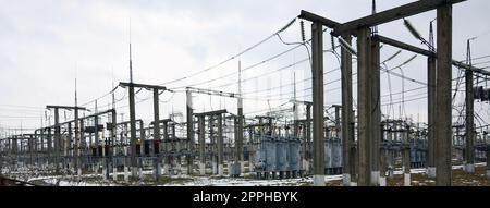 Power plant is a station of transformation. A lot of cables, poles and wires, transformers. Electro-energy. Stock Photo