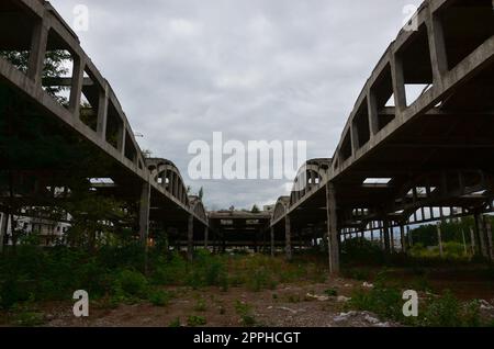 Landscape image of an abandoned industrial hangar with a damaged roof. Photo on wide-angle lens Stock Photo