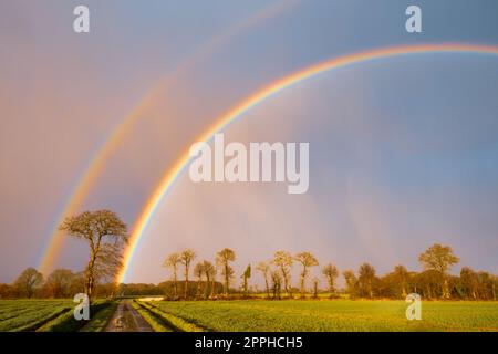 Rainbow over stormy sky in rural Brittany Stock Photo