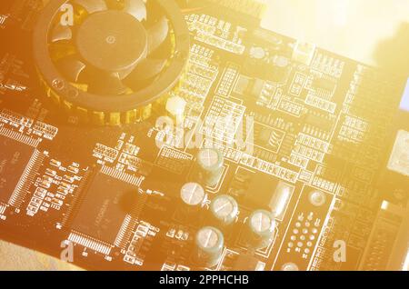 A toned macro image of a computer board with many small technological elements. Extremely shallow depth of field. Abstract technological background Stock Photo
