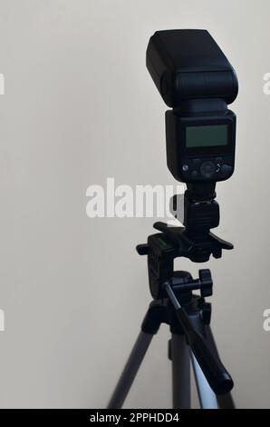 Speedlight gun with trigger set mounted on tripod Stock Photo