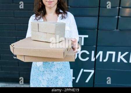 Happy woman holding many different cardboard boxes with online order, satisfied with fast delivery, buying high quality products. Stock Photo