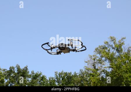 Drone with photocamera take off from land and flying for take aerial photo Stock Photo