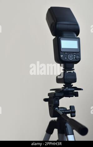 Speedlight gun with trigger set mounted on tripod Stock Photo