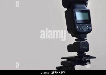 Speedlight gun with trigger set mounted on tripod Stock Photo