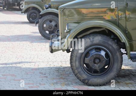 Photo of the cabins of three military off-road vehicles from the times of the Soviet Union. Side view of military cars from the front wheel Stock Photo