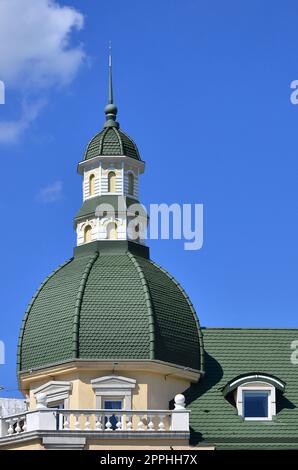 Completed perfect high-quality roofing work from metal roofing. The dome of a polyhedral shape with a spire is covered with green metal tiles Stock Photo