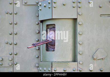 The texture of the wall of the tank, made of metal and reinforced with a multitude of bolts and rivets. Images of the covering of a combat vehicle from the Second World War with a guided machine gun Stock Photo