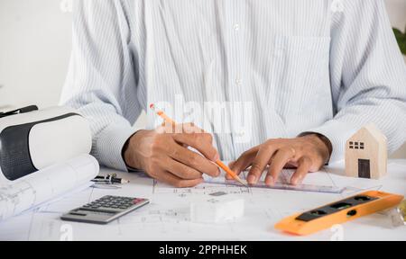 Architectural building design and construction plans with blueprints paper project plans VR glasses Stock Photo