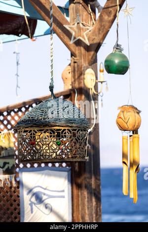 Restaurant with hanging decorations on the shores of the Red Sea in exotic small town on the Red Sea on the Sinai Peninsula, Dahab, Egypt. Stock Photo