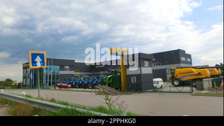 View of the New Holland Agriculture brand dealership. New Holland Agriculture is a global full-line agricultural machinery manufacturer belonging to the CNH Industrial. Stock Photo