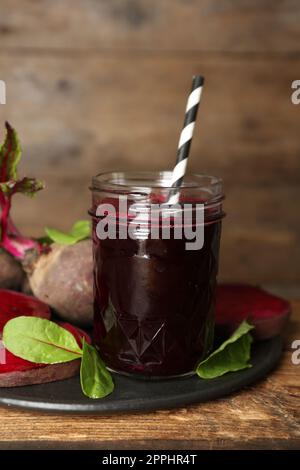 Freshly made beet juice on wooden table Stock Photo