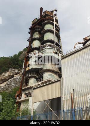 Mali Zvornik, Serbia, September 29 2022 Cement plant, Brasina mine. Industrial architecture. Smog and dirty dust air pollution industrial background on outdoor rock crushing and digging plant factory Stock Photo