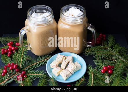 Candies and cocoa with marshmallows on a black background with white chocolate Stock Photo