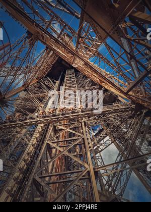 Eiffel Tower architecture details Paris, France. Underneath the metallic structure, steel elements with different geometric shapes Stock Photo