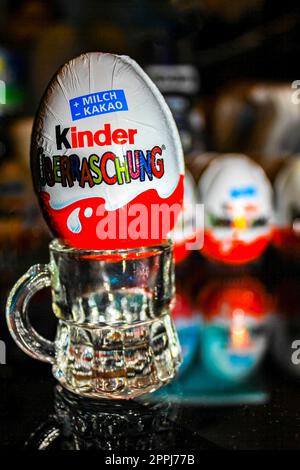 Kids Kinder surprise egg unwrap and enjoy chocolate and toys. Stock Photo