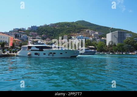 Budva, Montenegro, August 15 2022 Adriatic sea, coast, mountains, sea ripples. Boats and ships are moored to the embankment. Water transport parking. Summer resort trips with water activities. Tourism Stock Photo