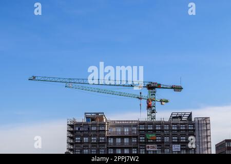 Kiel, Germany - 27.December 2022: Several cranes on constructions sites at high buildings. Stock Photo