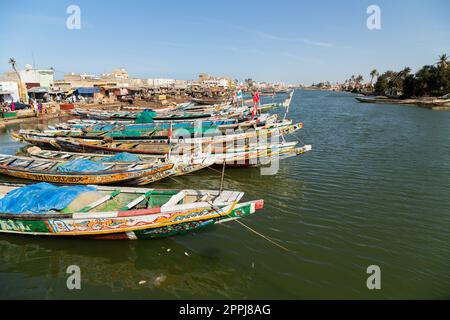 Fishing boats resting on the riverbank of the river senegal Stock Photo