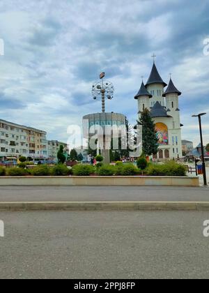 Falticeni, Romania - September 26, 2022: Main Square with Orthodox Church and World Clock Stock Photo
