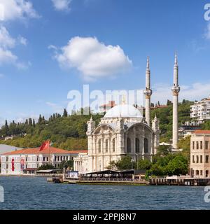 View from Bosphorus Strait overlooking Ortakoy Mosque, or Ortakoy Camii, suited at Ortakoy pier square, Istanbul, Turkey Stock Photo