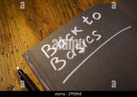Notebook with handwritten inscription back to basics. Stock Photo
