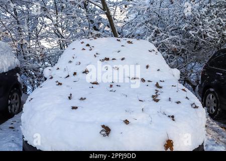 A car completely covered with thick snow after a snowstorm. Stock Photo