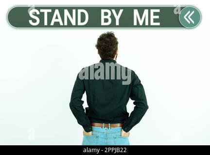 Hand writing sign Stand By Me. Word Written on Be always around myself there count on someone all the time Stock Photo