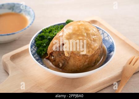 Tamsui agei (age, aburaage, ageh), delicious street food in Taiwan, stuffed with mung bean noodles and sauce topping. Stock Photo