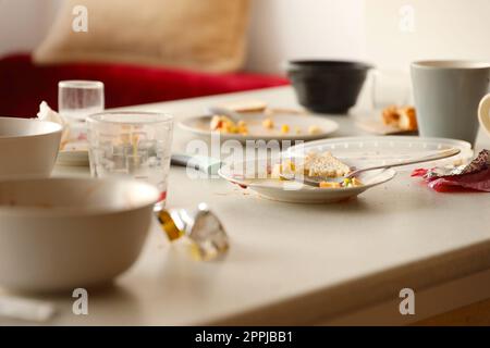 Empty dirty plates with spoons and forks on the table after meal. Banquet ending concept. Unwashed dishes Stock Photo