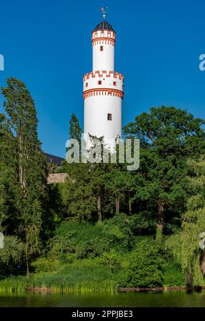 The white tower of the castle of Bad Homburg with the green foliage of the trees and cloudless blue sky Stock Photo