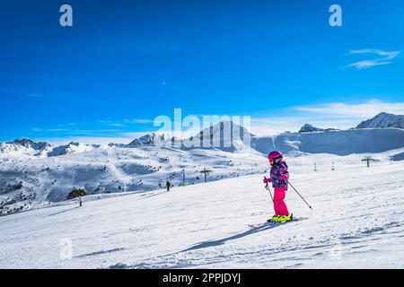 Young girl skiing down on a ski slop in Andorra, Pyrenees Mountains Stock Photo