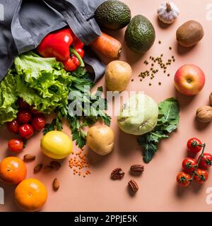 Healthy food background. Organic fruits, vegetables, vegan vegetarian raw food ingredients in textile bag. Delivery or grocery supermarket and clean v Stock Photo
