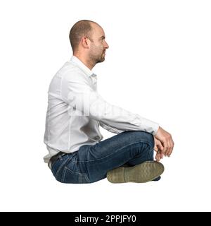 businessman sitting cross-legged, side view. Stock Photo