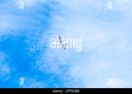 landing plane on blue sky with clouds Stock Photo - Alamy