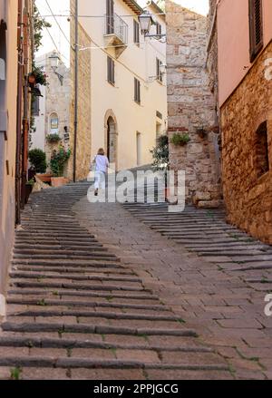 Steep and narrow street in old town of Massa Marittima, Italy Stock Photo