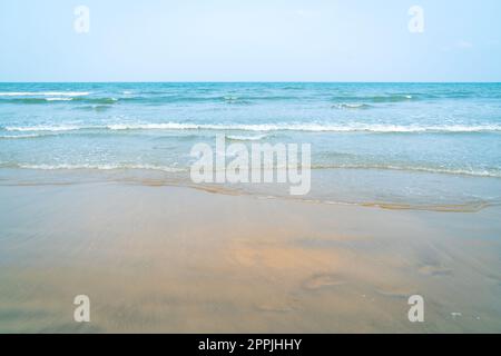 Tropical beach and seascape. Sunset hour, orange hue reflection on soft sand. Tranquil scene. Stock Photo
