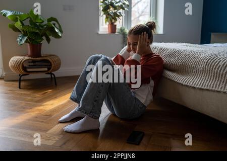 Frustrated teenage girl being bullied online, unhappy teen child dealing with first love heartbreak Stock Photo