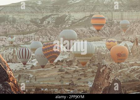 hot air balloons fly over the city of goreme at sunrise Stock Photo